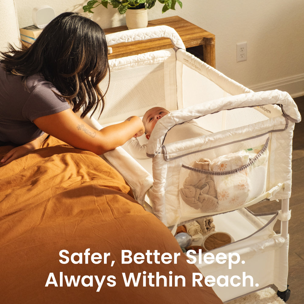 Woman with a baby in a crib next to a bed, with text 'Safer, Better Sleep. Always Within Reach.'