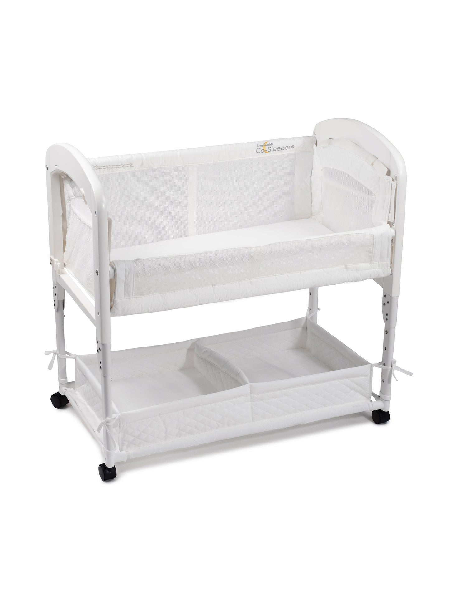 White baby crib with a lower shelf on a white background