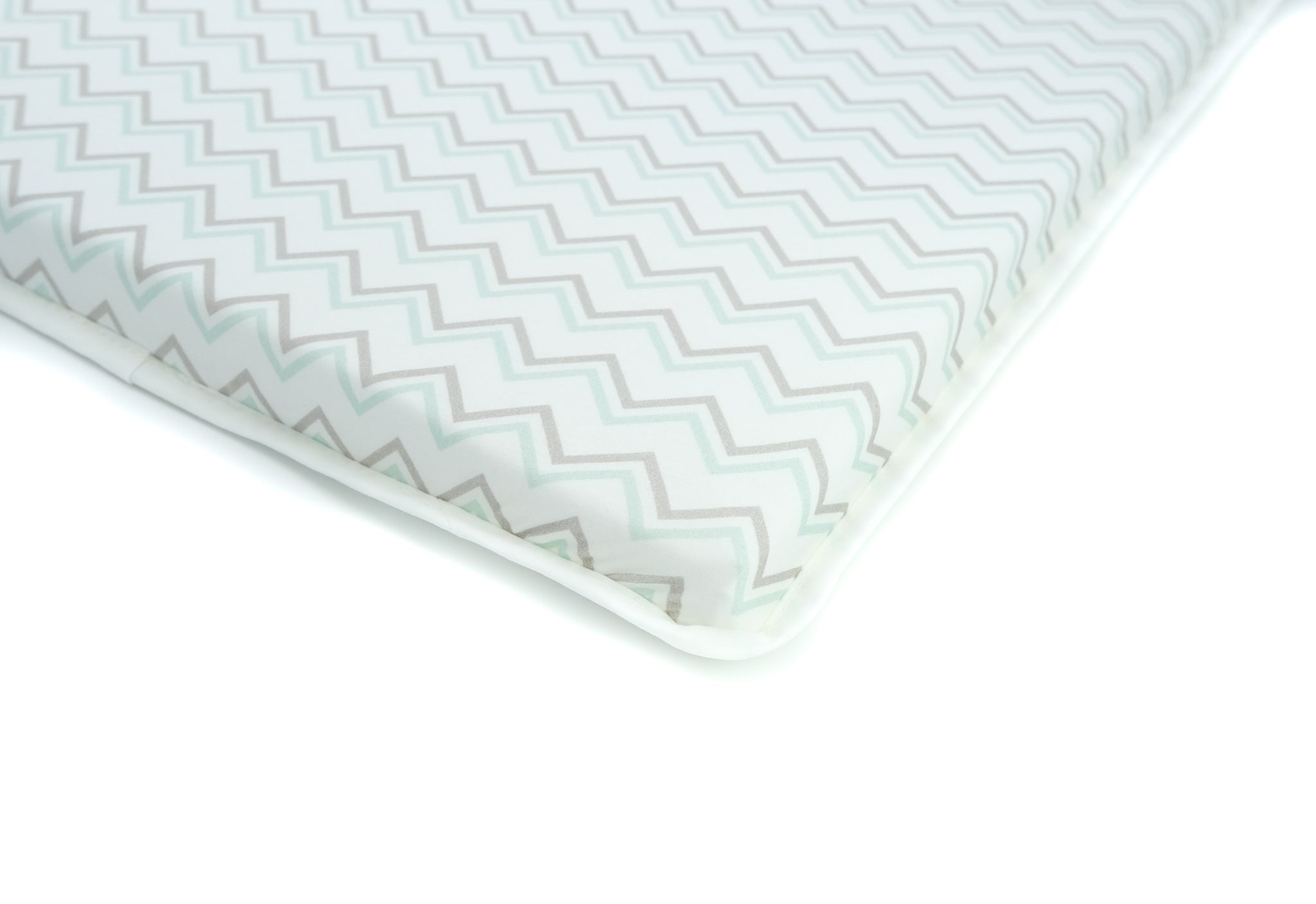 Printed cotton bassinet sheet shown on a Co-Sleeper bassinet